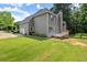 Expansive backyard with lush green lawn, mature trees, and a deck, ideal for outdoor enjoyment and entertaining at 13090 Magnolia Crescent Dr, Roswell, GA 30075