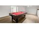 Basement with a pool table on laminate flooring and white walls at 13090 Magnolia Crescent Dr, Roswell, GA 30075