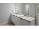 Bathroom with double sinks, granite countertops, and modern fixtures at 13090 Magnolia Crescent Dr, Roswell, GA 30075