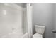 Clean bathroom features a tub/shower combo with new tile and modern toilet at 13090 Magnolia Crescent Dr, Roswell, GA 30075