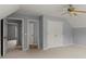 Spacious bedroom with double closets, neutral carpet, ceiling fan and two doors leading to other rooms at 13090 Magnolia Crescent Dr, Roswell, GA 30075
