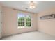 Bright bedroom offering neutral paint, comfortable carpet, and a view to the outdoors at 13090 Magnolia Crescent Dr, Roswell, GA 30075