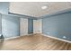 Blue bedroom showing laminate flooring, white doors and trim, and two different doors at 13090 Magnolia Crescent Dr, Roswell, GA 30075