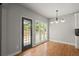 Bright dining room with hardwood floors, large windows, and access to the outdoor deck offers great space at 13090 Magnolia Crescent Dr, Roswell, GA 30075