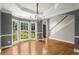 Elegant dining room with hardwood floors, large bay window, chandelier, and classic trim details at 13090 Magnolia Crescent Dr, Roswell, GA 30075