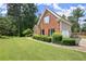 Well-maintained home with manicured lawn and mature trees creating a picturesque setting with great curb appeal at 13090 Magnolia Crescent Dr, Roswell, GA 30075