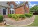 Brick home exterior showcasing front door, landscaped walkway, and charming curb appeal for a welcoming entry at 13090 Magnolia Crescent Dr, Roswell, GA 30075