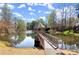 Charming gazebo on a tranquil pond, offering a peaceful retreat with lush surroundings and scenic beauty at 13090 Magnolia Crescent Dr, Roswell, GA 30075