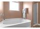 Cozy bathroom featuring a modern bathtub and shower combination at 1152 Werre Way, Locust Grove, GA 30248