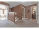 Upstairs hallway with neutral carpeting and doorways leading to various rooms at 1152 Werre Way, Locust Grove, GA 30248