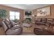 Spacious living room with a fireplace, large screen TV, and comfortable leather seating at 1152 Werre Way, Locust Grove, GA 30248