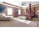 Elegant primary bedroom with decorative pillars, sitting area and lots of natural light at 1152 Werre Way, Locust Grove, GA 30248