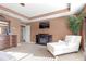 Inviting primary bedroom featuring a TV, fireplace, and comfortable chaise lounge at 1152 Werre Way, Locust Grove, GA 30248
