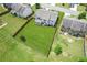 An aerial view shows the property featuring a large, fenced backyard with lush green grass and a covered patio at 4650 Orchard View Way, Cumming, GA 30028