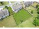 Aerial view of a large, fenced backyard with lush green grass and a covered patio with nice home elevation at 4650 Orchard View Way, Cumming, GA 30028