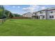 Spacious backyard featuring lush green lawn, wooden fence, and covered patio perfect for outdoor entertaining at 4650 Orchard View Way, Cumming, GA 30028