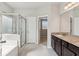 Primary bathroom featuring soaking tub, glass enclosed shower, and granite countertop with dual sinks at 4650 Orchard View Way, Cumming, GA 30028