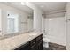 Bathroom featuring dark cabinets, granite countertops, tile floors, and shower/tub combo at 4650 Orchard View Way, Cumming, GA 30028