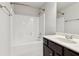 Bathroom with a bath tub, shower, dark wood cabinets, and white countertop at 4650 Orchard View Way, Cumming, GA 30028