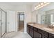 Bathroom showcasing soaking tub, glass enclosed shower, and granite countertop with dual sinks at 4650 Orchard View Way, Cumming, GA 30028