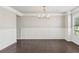 Bright dining room features hardwood floors, stylish chandelier and decorative wall trim at 4650 Orchard View Way, Cumming, GA 30028
