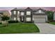 Beautiful two-story home with well-manicured lawn, gray brick, and two-car garage at 4650 Orchard View Way, Cumming, GA 30028
