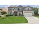 Beautiful two-story home with well-manicured lawn, gray brick, and two-car garage at 4650 Orchard View Way, Cumming, GA 30028