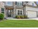 Exterior shot of a home with a manicured lawn, gray brick accents, and two-car garage at 4650 Orchard View Way, Cumming, GA 30028