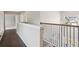 Second story hallway with hardwood floors and wrought iron railing overlooking the main level at 4650 Orchard View Way, Cumming, GA 30028