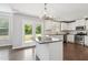 Open kitchen with island, stainless steel appliances, and access to the outdoor deck at 4650 Orchard View Way, Cumming, GA 30028