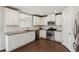 Charming kitchen features white cabinets, stainless steel appliances, and granite countertops at 4650 Orchard View Way, Cumming, GA 30028