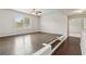 Living room area with raised platform seating, hardwood floors, ceiling fan and natural light at 4650 Orchard View Way, Cumming, GA 30028