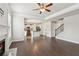 Open-concept living room leads to kitchen and staircase, with hardwood floors throughout at 4650 Orchard View Way, Cumming, GA 30028
