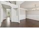 Bright living room showcasing dark wood floors, wainscoting, and elegant chandelier at 4650 Orchard View Way, Cumming, GA 30028