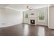 Spacious living room features hardwood floors and fireplace with marble surround at 4650 Orchard View Way, Cumming, GA 30028
