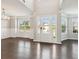 Bright and airy living room boasting wood floors, wainscoting, and large windows at 4650 Orchard View Way, Cumming, GA 30028