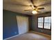 Bedroom featuring a ceiling fan, closet, and a window at 542 Banks E Rd, Fayetteville, GA 30214