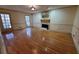 Large living room with hardwood floors, a fireplace, and natural light from the windows at 542 Banks E Rd, Fayetteville, GA 30214