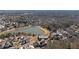 Stunning aerial view of the property located at 7165 Cordery Rd near a beautiful lake and lush greenery at 7165 Cordery Rd, Cumming, GA 30040