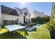 Entertainer's backyard with a pristine pool, ping pong, lounge chairs, and a grill setup for outdoor enjoyment at 7165 Cordery Rd, Cumming, GA 30040