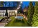 Inviting backyard space with a ping pong table, sun loungers, and lush greenery for a serene outdoor experience at 7165 Cordery Rd, Cumming, GA 30040