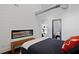 Charming bedroom with shiplap walls, a sleek fireplace, and seamless access to the adjacent kitchen area at 7165 Cordery Rd, Cumming, GA 30040