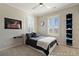 Modern bedroom with a white bed, unique wall art, and bright windows at 7165 Cordery Rd, Cumming, GA 30040