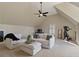 A spacious bonus room with comfortable seating and a ceiling fan at 7165 Cordery Rd, Cumming, GA 30040