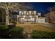 Charming two-story home with a welcoming front porch, lush lawn, and manicured landscaping at 7165 Cordery Rd, Cumming, GA 30040