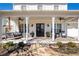 Inviting front porch with stylish seating, ceiling fans, and black double front doors at 7165 Cordery Rd, Cumming, GA 30040