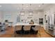 Bright, open kitchen featuring a large island, modern appliances, and stylish pendant lighting at 7165 Cordery Rd, Cumming, GA 30040