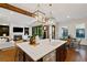 Spacious kitchen with large island, modern appliances, pendant lighting, and open living area at 7165 Cordery Rd, Cumming, GA 30040