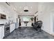 Bright living room featuring soaring ceilings, shiplap walls, and open to the kitchen with stainless appliances at 7165 Cordery Rd, Cumming, GA 30040