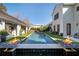 Luxurious pool area with fire features, lush landscaping, and elegant design, perfect for outdoor entertaining at 7165 Cordery Rd, Cumming, GA 30040